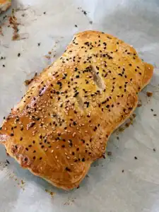 Freshly baked Crab Rangoon hand pies cooling in the pan