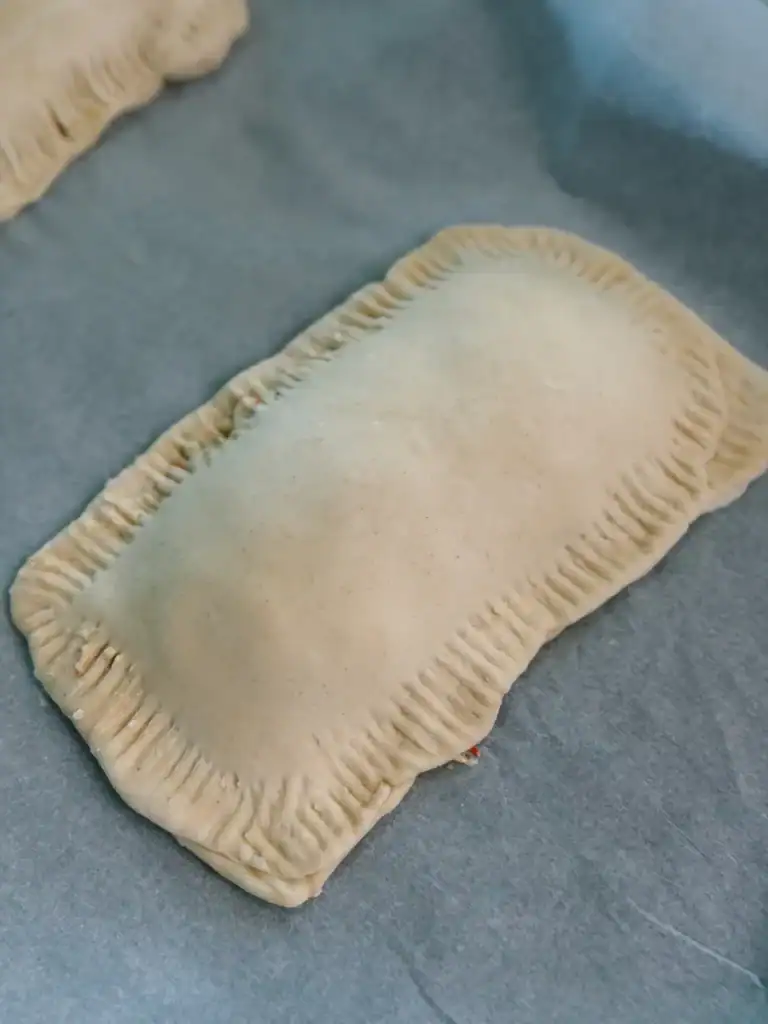 Frozen puff pastry wrapped around crab filling for crab Rangoon hand pies