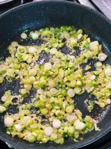 Sauteeing Green onion and ginger in chicken fat for Crispy Chicken with Ginger Scallion Rice