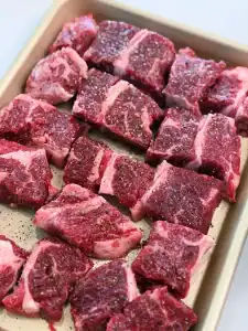 Adding salt and pepper to beef short rib for Taiwanese Birria Tacos