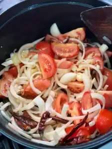 Sauteeing onion, tomatoes, and seasoning for Taiwanese Birria Taco