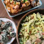 NFL Draft Day Party Spread with Salmon Poke Wonton Nachos, Creamy Chicken Sausage Pasta Salad, and Mini Spam Rice Balls