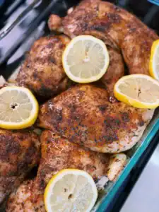 Adding fresh lemon slices for the 2nd roast of Oven Roasted Chicken Legs