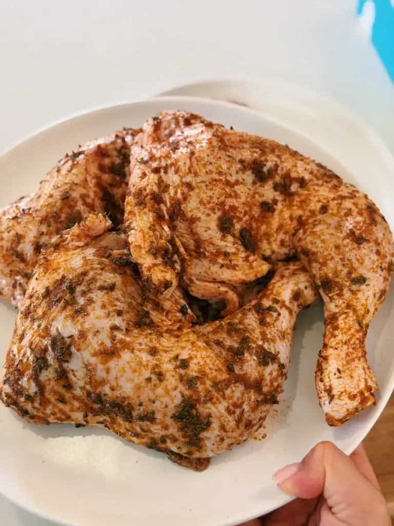 Seasoned chicken legs ready for roasting to make Oven Roasted Chicken Legs