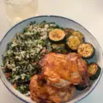 A plate of Taiwanese Five Spice Chicken Thigh with pan fried zucchini and furikake veggie rice