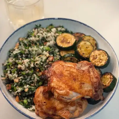 A plate of Taiwanese Five Spice Chicken Thigh with pan fried zucchini and furikake veggie rice