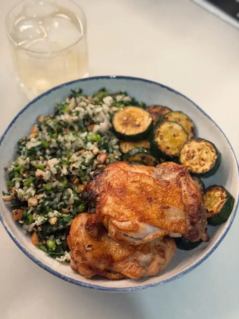 A plate of Taiwanese Five Spice Chicken Thigh with pan fried zucchini and furikake veggie rice