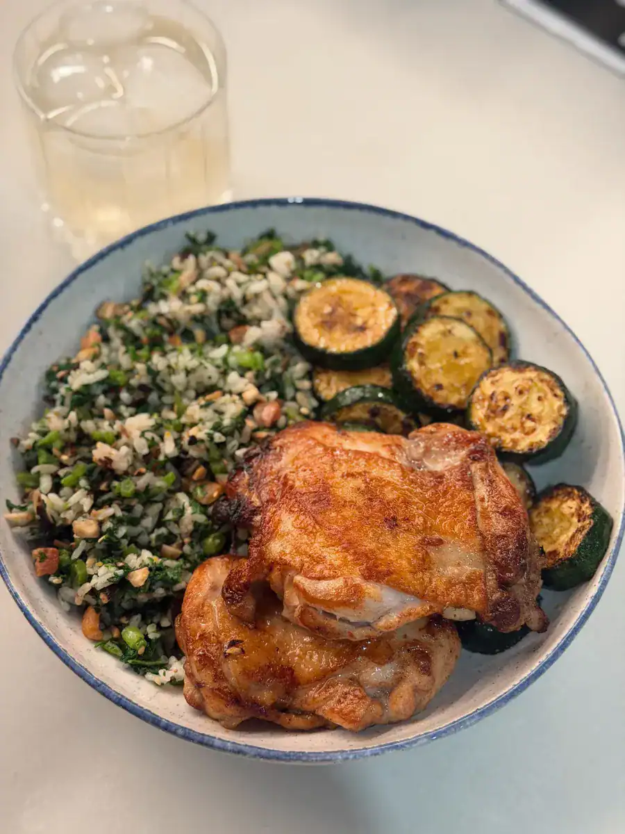 A plate of Taiwanese Five Spice Chicken Thigh with pan fried zucchini and furikake veggie rice