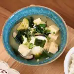 A bowl of Vegetable Miso Soup packed with mushrooms, seaweed, zucchini, egg, and tofu