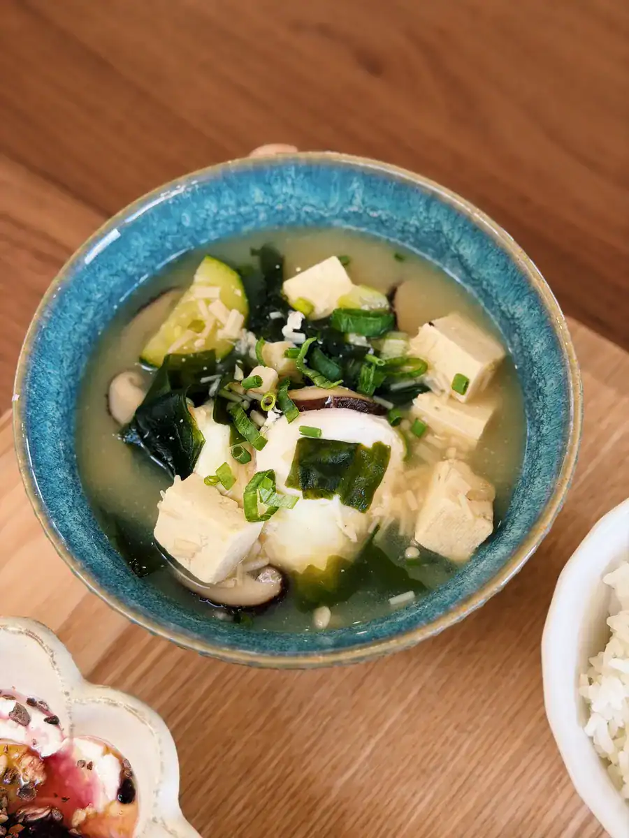 A bowl of Vegetable Miso Soup packed with mushrooms, seaweed, zucchini, egg, and tofu