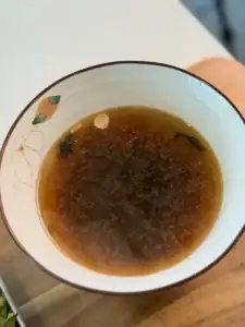 Soup base for Breakfast noodle soup, using dashi, soy sauce, pepper, sesame oil, and hot noodle water
