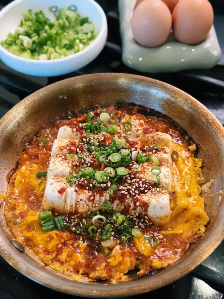 Spicy Garlic Tofu Omelette served with sesame seeds and chopped green onions